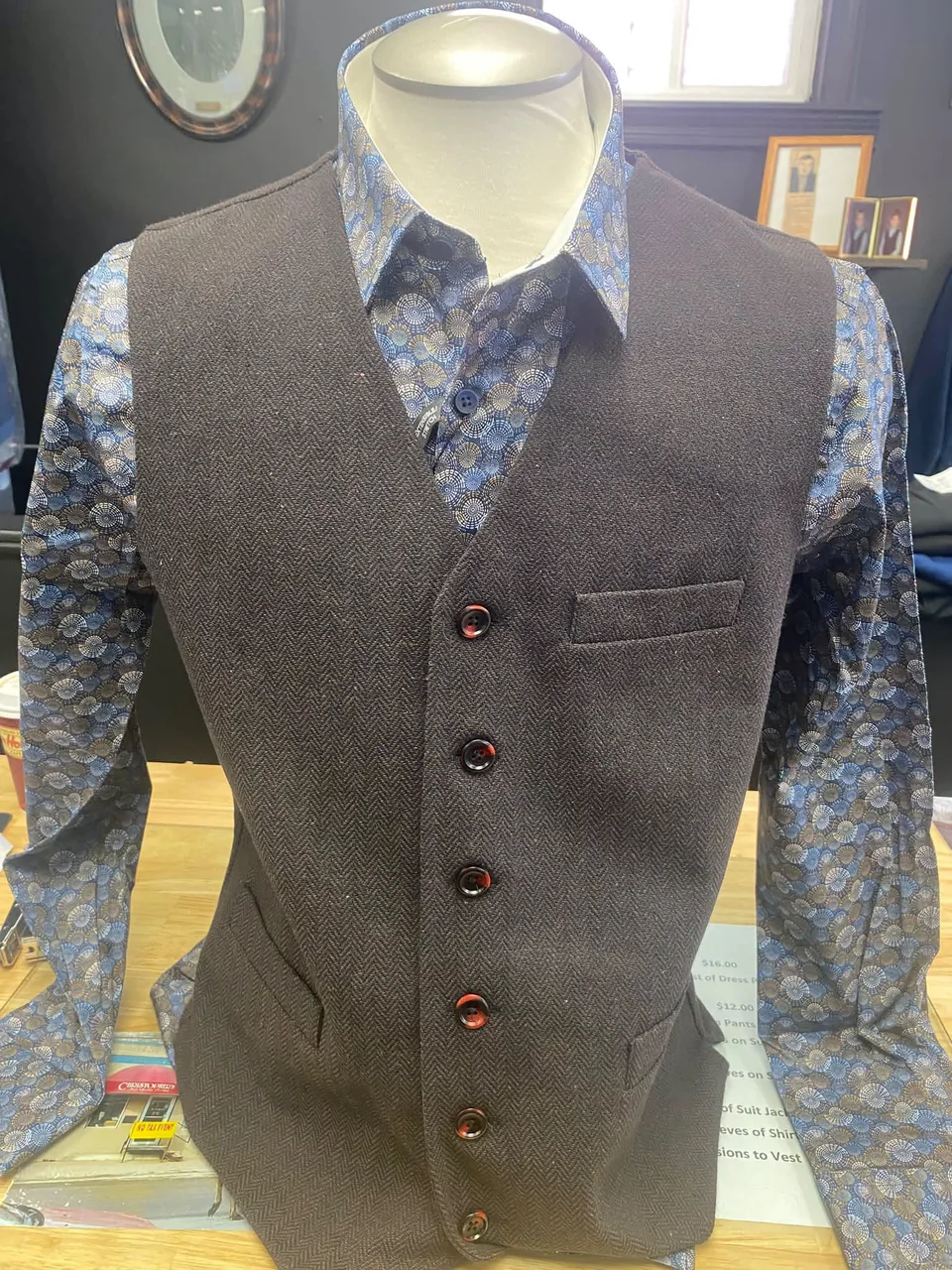 Textured waistcoat over a blue patterned shirt on a mannequin inside Christopher’s Menswear